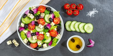 Greek salad with fresh tomatoes olives and feta cheese healthy eating food from above on slate banner in Stuttgart