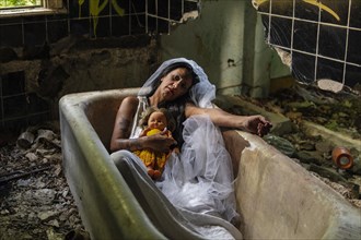 Deranged bride with a doll in a bathtub. Inspired by the traditional American legend of la llorona