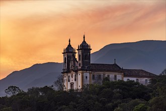 Historic baroque church on top of the hill during sunset in Ouro Preto city in Minas Gerais