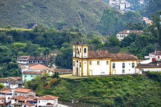 View from above of one of the several historic churches in baroque style in the city of Ouro Preto in Minas Gerais with houses and colonial style around it.