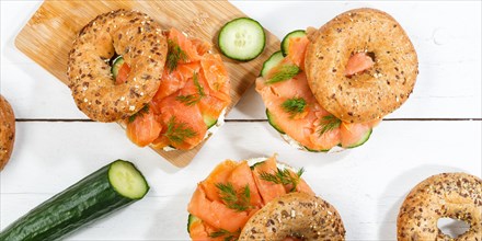 Bagel sandwich for breakfast topped with salmon fish from above on a wooden board Panorama in Stuttgart