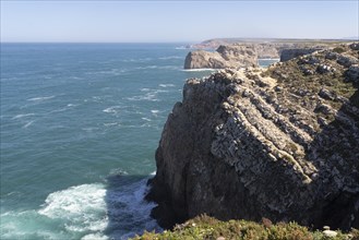 Surf of the Atlantic Ocean and rocky cliffs at Cape Cabo de Sao Vicente