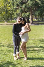 Happy pregnant lesbian couple at outdoors. LGBT