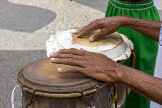 Percussionist playing a rudimentary atabaque during afro-brazilian cultural manifestation at Pelourinho on Salvador city