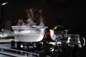 Hot water in transparent pot on gas stove