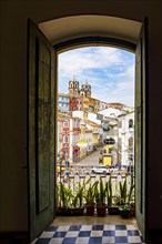 Open door in an old colonial house overlooking the Pelourinho neighborhood and its hillsides in Salvador