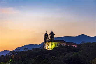 Historic church in baroque style on top of the mountain in Ouro Preto city in Minas Gerais during sunset