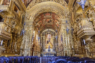 Interior and altar of a brazilian historic ancient church from the 18th century in baroque architecture with details of the walls in gold leaf in the city of Rio de Janeiro