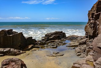 View of the sea and horizon between the rocks with blue sky in a sunny summer day
