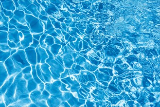 Wavy blue water surface with reflections