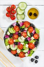 Greek salad with fresh tomatoes olives and feta cheese healthy eating food from above on wooden board in Stuttgart