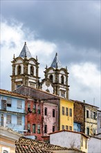 Historic baroque church towers rising between old colorful houses in the Pelourinho neighborhood in the city of Salvador