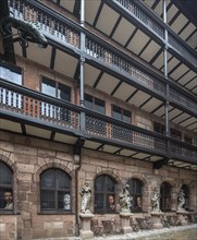 Historic courtyard with galleries and sculptures of the four seasons