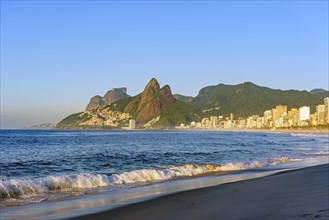 Dawn at Ipanema beach in Rio de Janeiro still empty with its buildings and mountains around