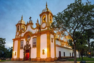 Historic church in the city of Tiradentes in Minas Gerais with its facade lit up at dusk