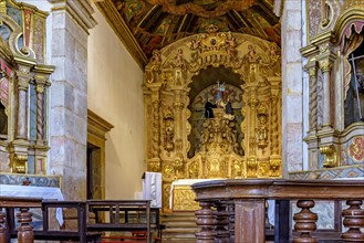 Interior and altar of an old baroque church with gold-leafed walls in the historic city of Tiradentes in Minas Gerais