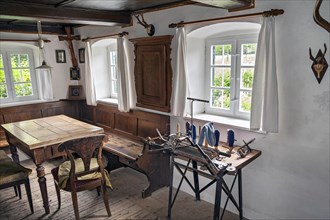 Farmhouse parlour with rustic corner and old knitting machine