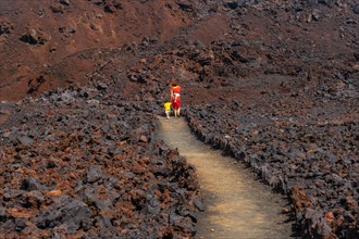 Walking through the beautiful red volcano in the town of Tamaduste on the coast of the island of El Hierro