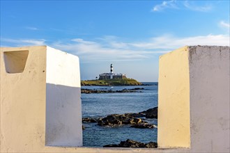 Historic Barra Lighthouse seen through the walls of the old fortress of Santa Maria in the city of Salvador in Bahia