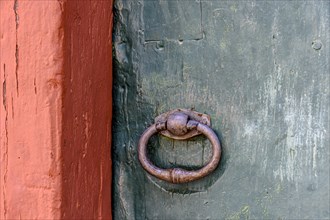 Detail of antique wooden colorful door and lock deteriorated by time and rust in a colonial style house in the historic city of Diamantina in Minas Gerais
