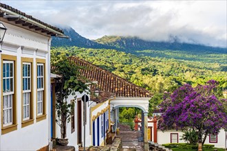 Historic colonial houses with the mountain and forest vegetation lit by the sun in the city of Tiradentes in Minas Gerais