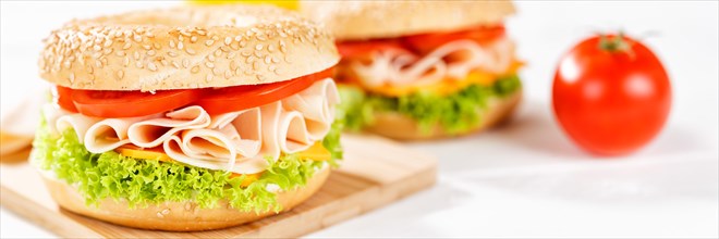 Bagel sandwich for breakfast topped with chicken ham close up panorama in Stuttgart