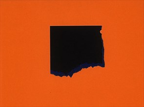Torn orange paper with black hole