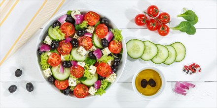 Greek salad with fresh tomatoes olives and feta cheese healthy eating food banner from above on wooden board in Stuttgart