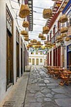 Streets of the historic city of Diamantina in Minas Gerais with its bars and restaurants with tables and chairs on the cobbled sidewalks