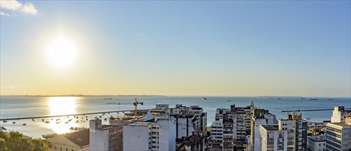Buildings and port of the city of Salvador with the bay of All Saints in the background during sunset in Bahia state