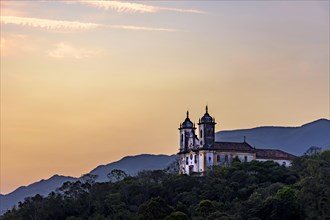 Ancient and historic church on top of the hill during sunset in the city of Ouro Preto in Minas Gerais