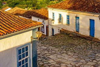 Cobbled street and colorful colonial-style houses in the afternoon on the old and historic city of Tiradentes in Minas Gerais