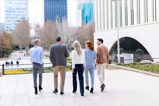 Walking out of work. Group executives or businessmen and businesswoman in a business area