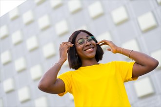 Stylish Black Woman in Yellow Tee: A Vibrant Portrait of Urban Fashion and Confidence