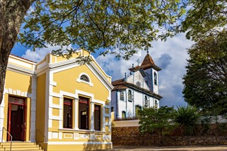 Facade of old colonial style house and baroque church in the historic town of Diamantina in Minas Gerais