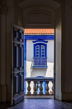 Old colonial houses seen through the door of historic church in the city of Diamantina in Minas Gerais