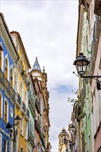 Facades of old houses and church towers in colonial style in the streets of the Pelourinho neighborhood in the city of Salvador