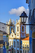Colorful colonial houses facades and historic church towers in baroque and colonial style with blue sky in the famous Pelourinho district of Salvador