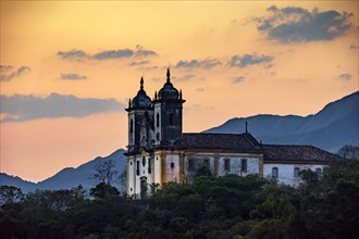 Ancient and historic church on top of the hill during sunset in the city of Ouro Preto in Minas Gerais