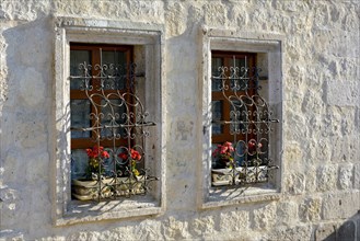 Window and red flowers in a house in the town of Goreme in Cappadocia