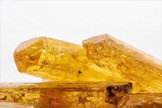 Studio photography of some Brazilian imperial topaz in raw state with white background