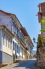 Cobblestone street with old and colorful colonial houses in the historic city of Ouro Preto in the state of Minas Gerais