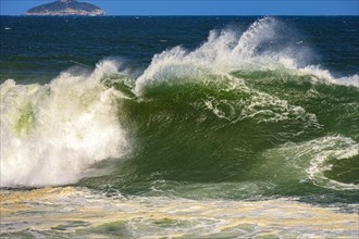 Big wave breaking at Ipanema beach in Rio de Janeiro on a sunny day and strong winds