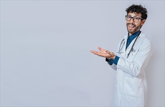Handsome doctor showing an advertisement with his palms