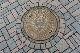 Manhole cover plate with city coat of arms