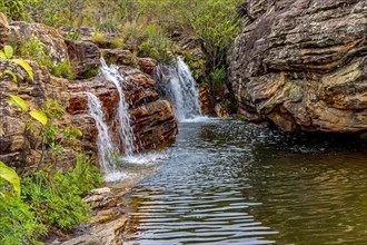 Beautiful and small waterfall among the rocks and vegetation of the Biribiri environmental reserve in Diamantina