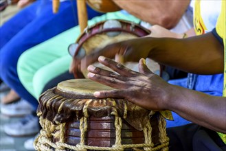 Percussion instrument called atabaque being played in traditional afro-brazilian capoeira presentation