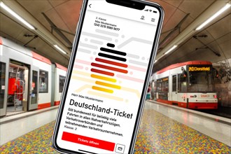 Germany ticket D-ticket or 49 euro ticket on a mobile phone with a light rail metro underground photo montage in Dortmund