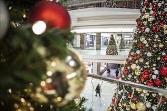 People stand out against Christmas decorations in a shopping centre on Schlossstrasse in Berlin
