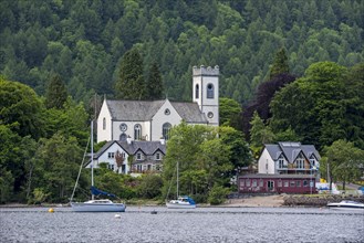 Kenmore Parish Church and sailing boats in Loch Tay